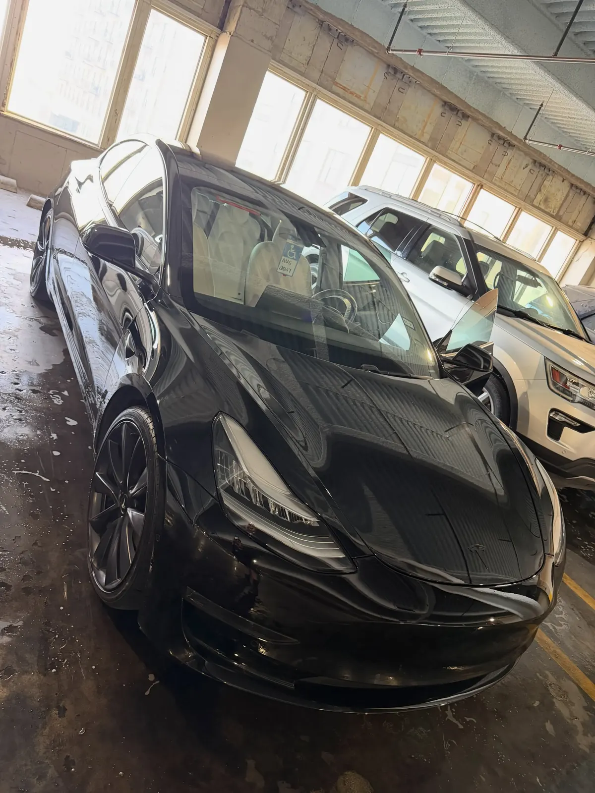 Black Tesla detailed inside a garage