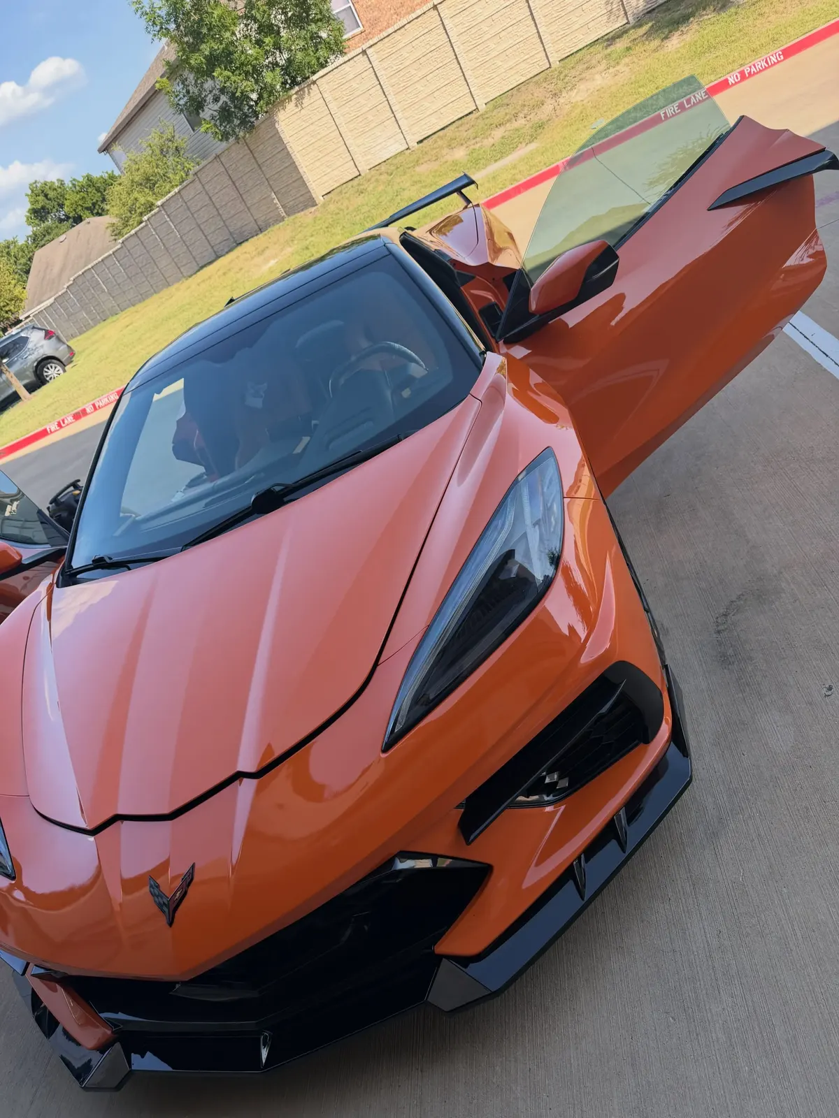 Orange Corvette detailed and gleaming in the sun