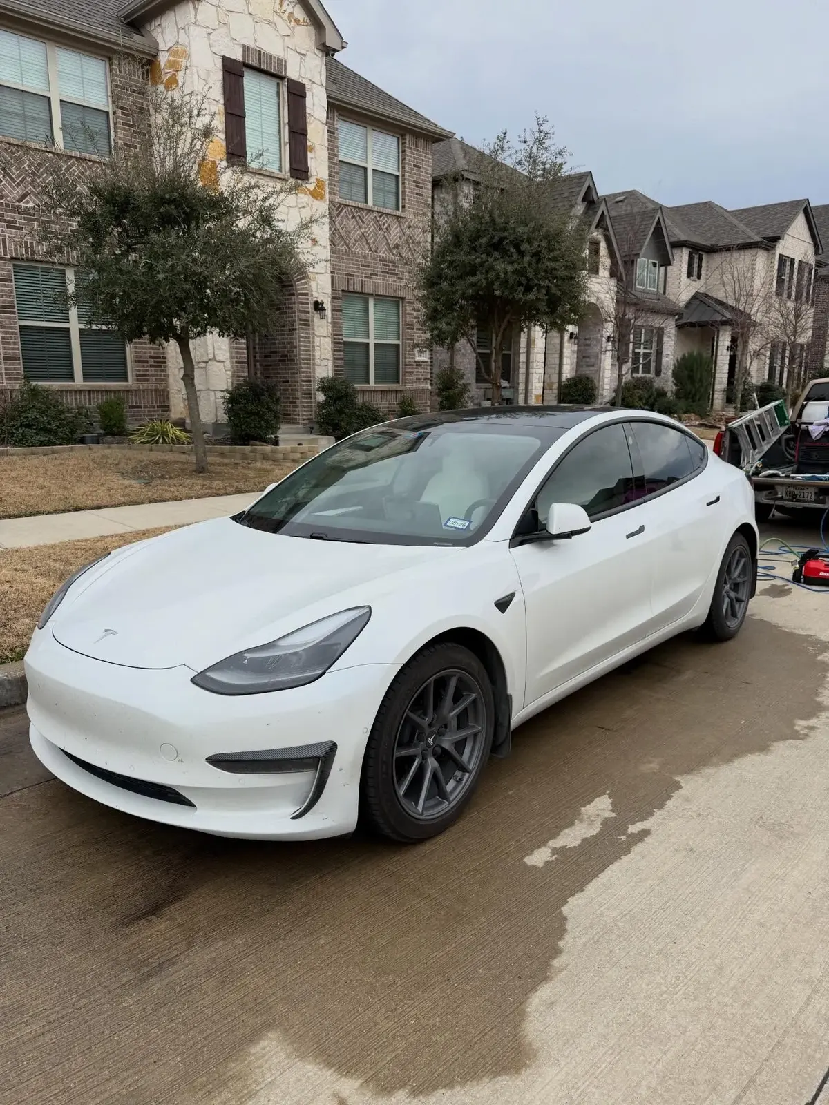 Ceramic-coated white Tesla with a mirror-like reflection