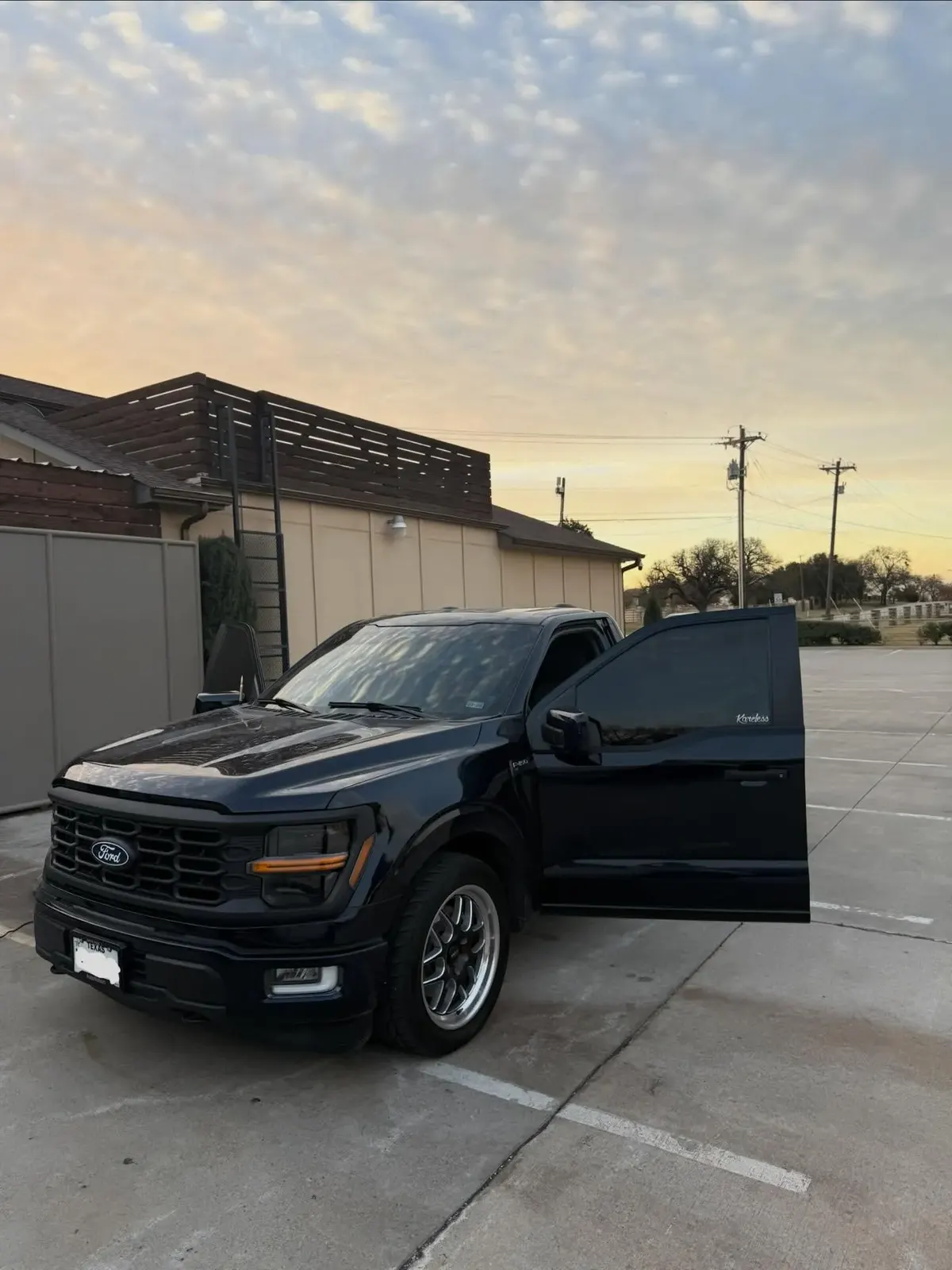 Black Ford F-150 detailed at sunset